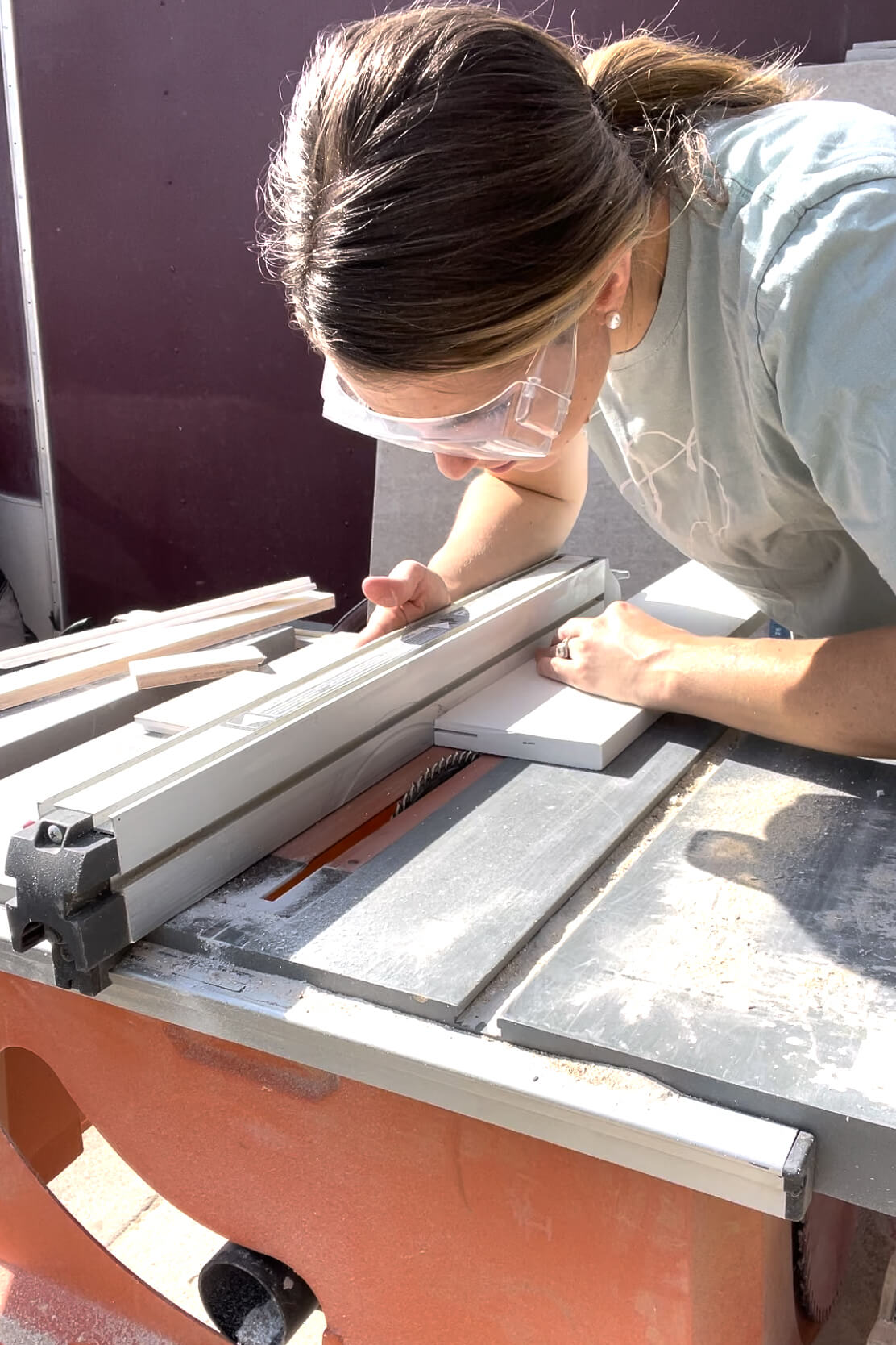 Using a table saw to cut PVC trim.